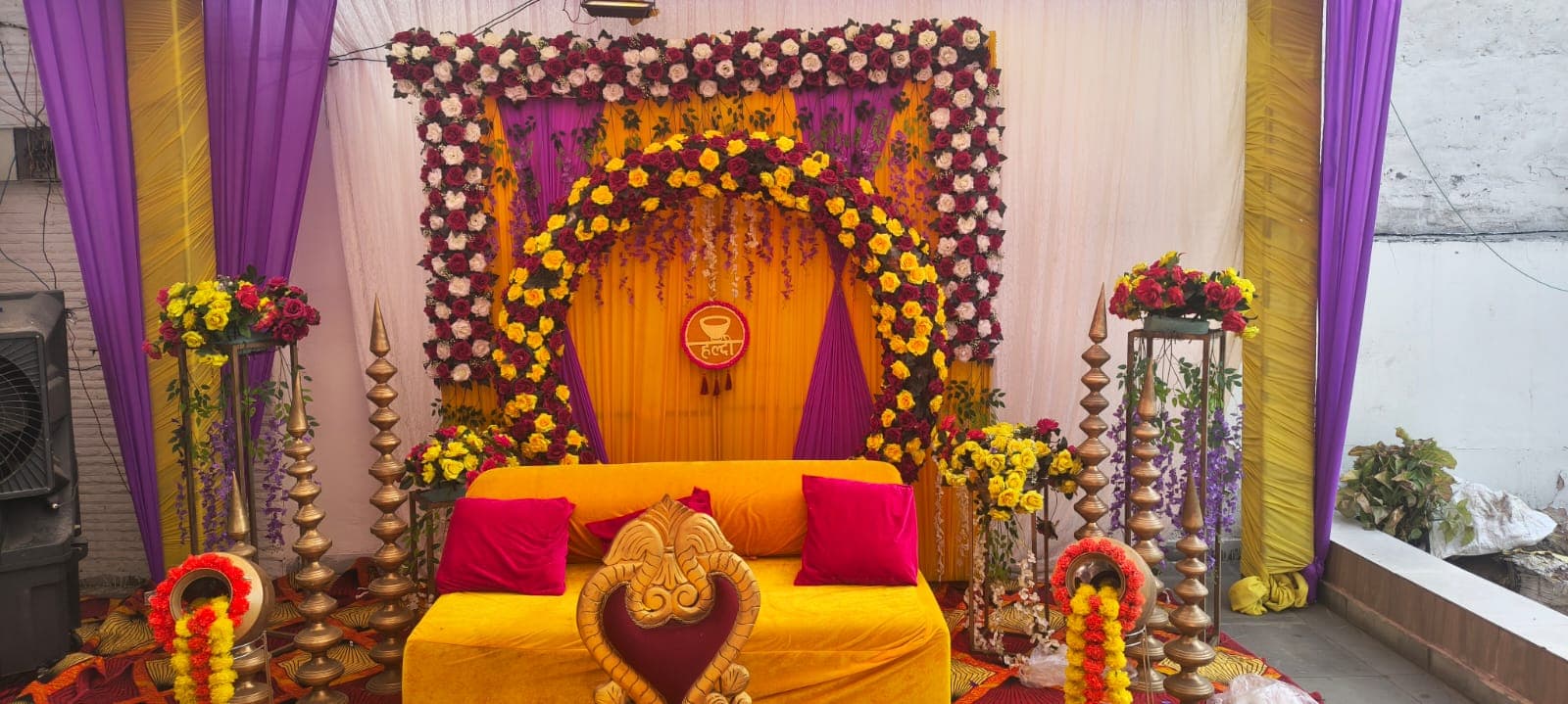 Real celebration setup with golden lotus Urlis, marigold decor and traditional tent architecture by Shri Raghav Ji Tent House